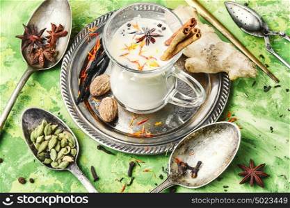 Masala tea ingredients. glass of Indian tonic tea with milk and spicy spices