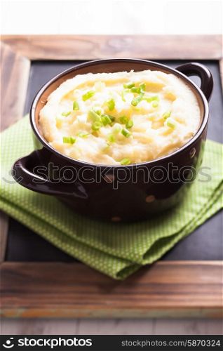 Mashed potato in a bowl with green onion