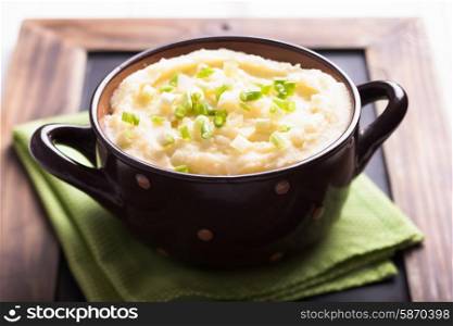 Mashed potato in a bowl with green onion