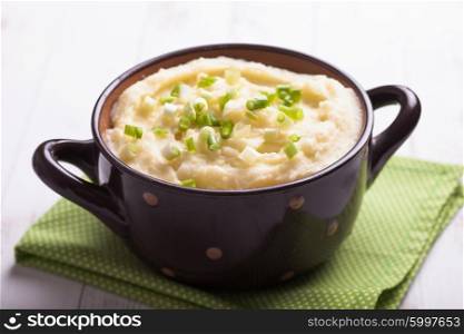 Mashed potato in a bowl with green onion. The Mashed potato