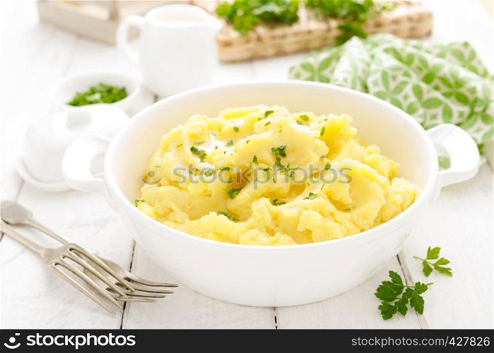 Mashed potato with butter and milk on table