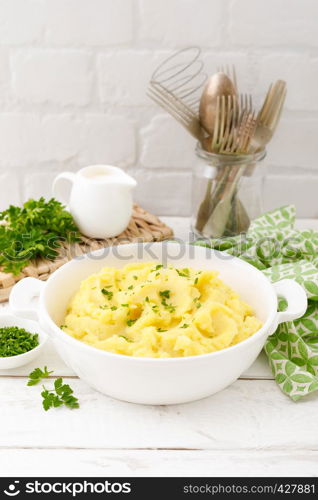 Mashed potato with butter and milk on table