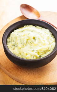 Mashed potato with dill in organic clay bowl