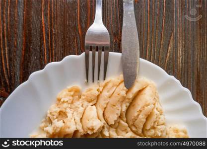 Mashed potatoes top view with fork and knife