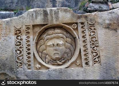Mask on the stone in theater, Myra, Turkey