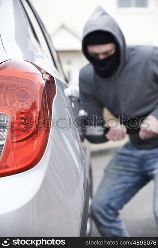 Masked Man Breaking Into Car With Crowbar