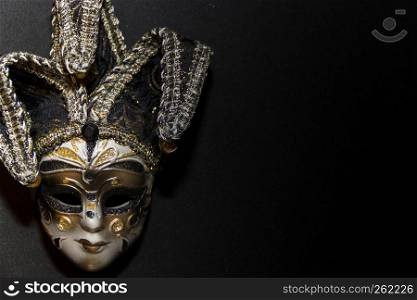 masks and feathers of venice carnival on black background