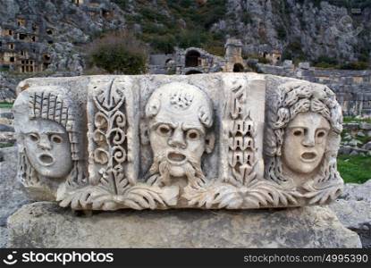 Masks and rock tombs in Myra, Turkey