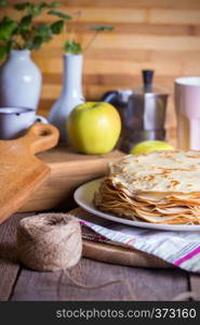 Maslenitsa and pancake week. dish full of russian tradition pancakes with sour cream at saucer