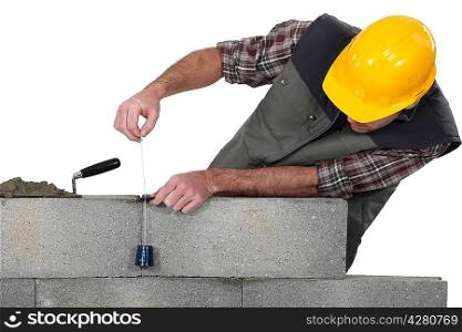 Mason building a bricks wall
