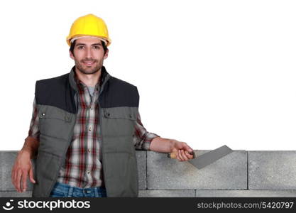mason leaning on a wall