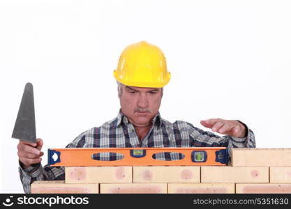 Mason leveling brick wall