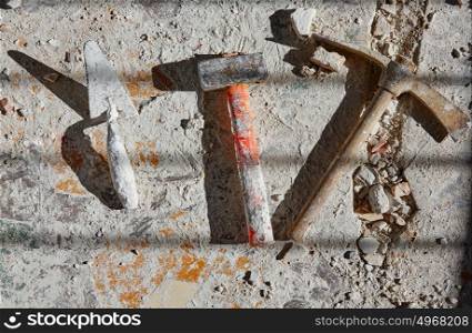 Mason tools on debris background in house improvement construction