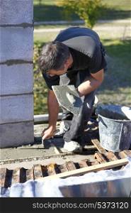 Mason with trowel and cement