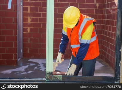 mason worker performing work on the construction site of house