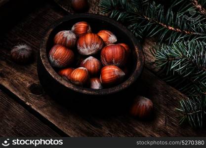 mass forest hazelnut. hazelnut in wooden bowl on a retro background