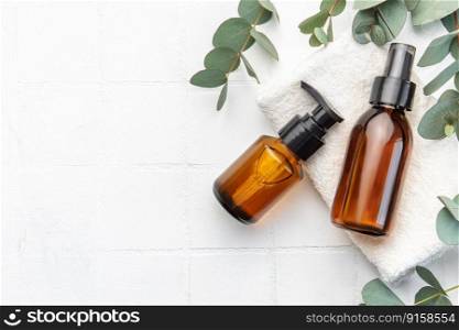 Massage and Spa products with eucalyptus on a white tile background