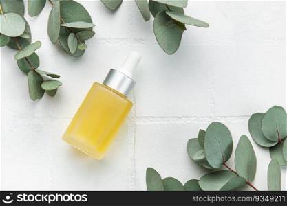 Massage and Spa products with eucalyptus on a white tile background