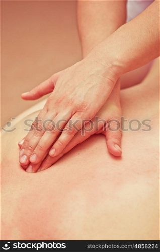 massage at spa. Woman having a massage at spa