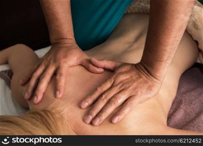 massage at spa. Woman having a massage at spa