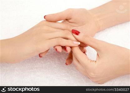 Massage of the female well-groomed hands, isolated