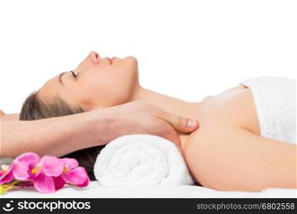 massage the shoulders of a young beautiful woman in spa salon