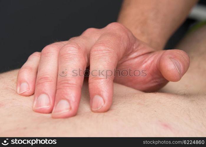 Massage therapist is working with a client