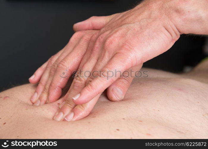 Massage therapist is working with a client