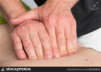 Massage therapist is working with a client