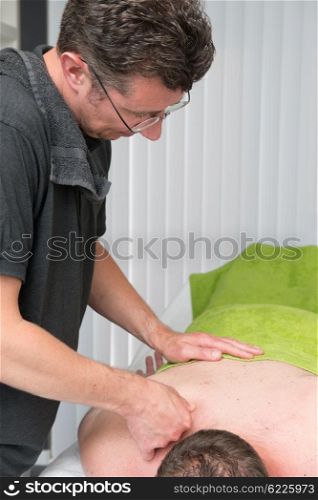 Massage therapist is working with a client