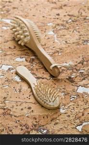massager and hairbrush on cork wood