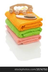 massager and hairbrush on towels
