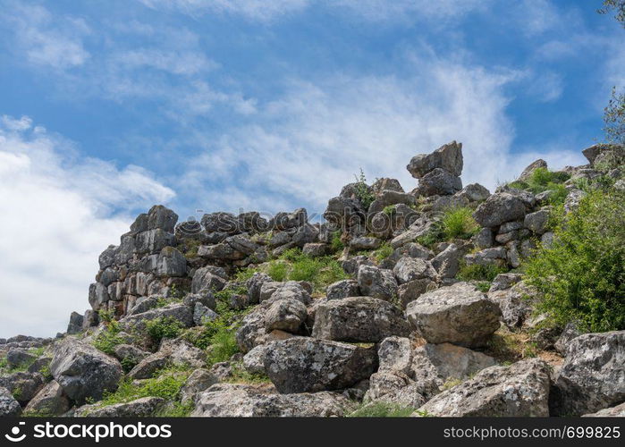 Massive boulders form the walls of the fortress and palace of Tiryns in Greece. Ancient Greek historic site of Tiryns in Peloponnese Greece