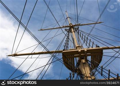 Mast of a big old sailing ship. Mast and rigging of a big old sailing ship in front of a blue sky