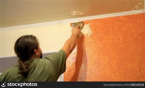 Master applies colored wax on ornamental plaster.