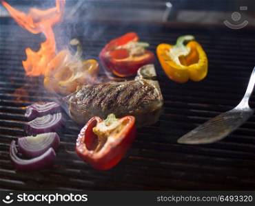 Master chef cooking delicious grilled meat steak with vegetables on a barbecue. chef cooking steak with vegetables on a barbecue