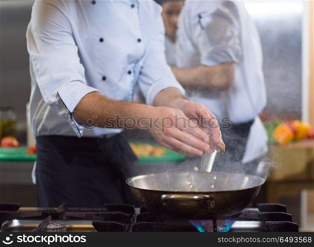 Master chef preparing food, frying in wok pan. Sale and food concept. chef preparing food, frying in wok pan