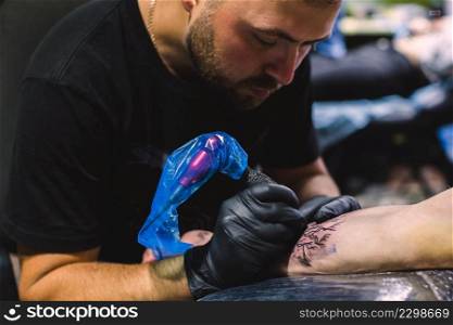 master doing tattoo with iron salon