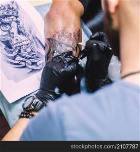 master making tattoo with iron