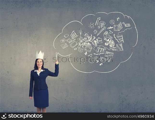 Master of creativity. Young businesswoman in paper crown and speech balloon in hand
