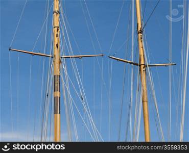 Masts of yachts over blue sky