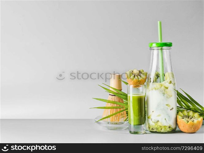 Matcha espresso in glass and matcha fusion kiwi latte mix in bottle with drinking straw. Healthy antioxidant boost drink. Detox and clean eating concept. Summer refreshing beverages.