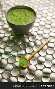 Matcha green tea from Japan on modern stainless steel background