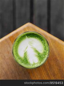 Matcha latte on wooden background top view