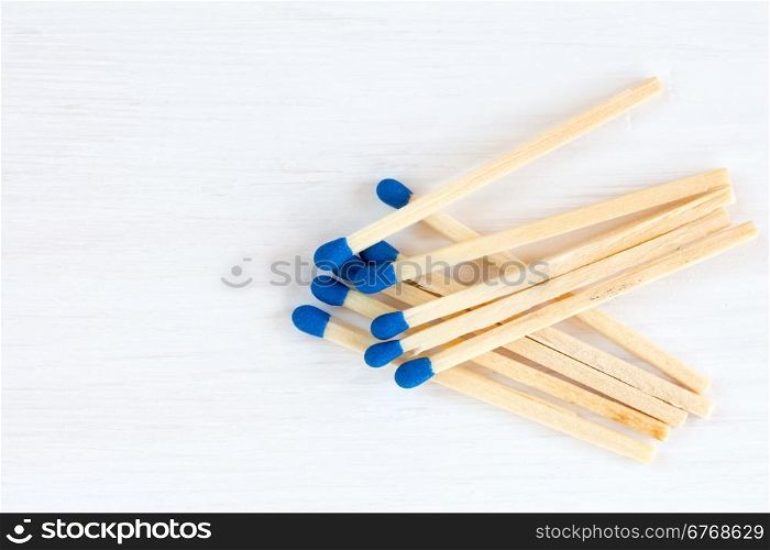 Matches on white wooden background with copy space
