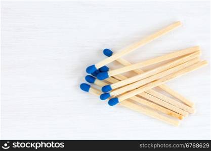 Matches on white wooden background with copy space