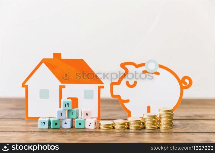 math blocks increasing stacked coins front house piggybank