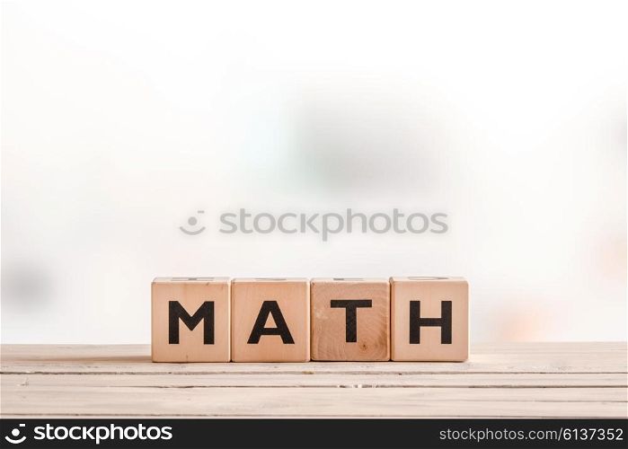 Math lesson sign made of cubes on a wooden table