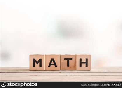 Math lesson sign made of cubes on a wooden table