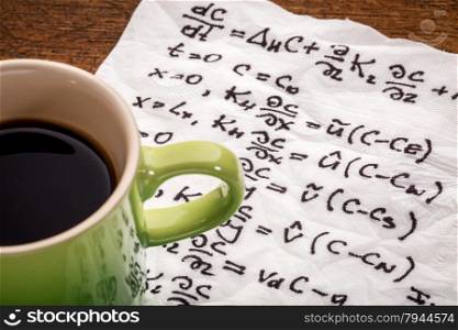 mathematical equations of physics - handwriting on a napkin with a cup of coffee